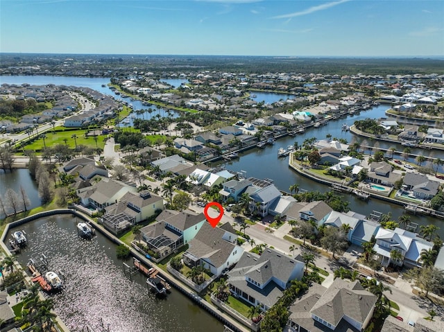 drone / aerial view featuring a water view and a residential view