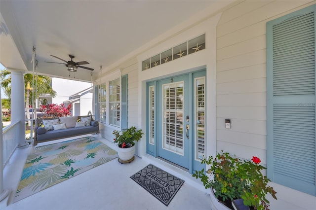 entrance to property with covered porch and ceiling fan