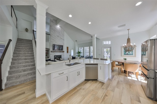 kitchen featuring light countertops, visible vents, appliances with stainless steel finishes, white cabinetry, and a sink