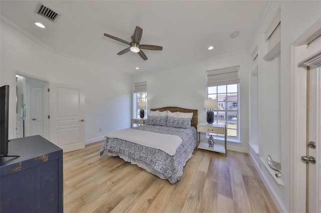 bedroom featuring visible vents, light wood-style flooring, baseboards, and multiple windows