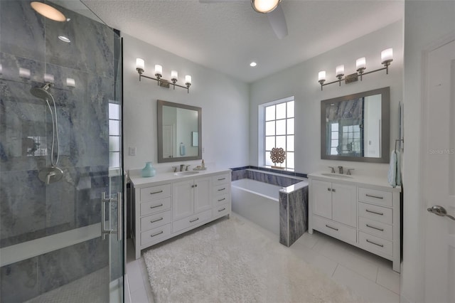 bathroom with a stall shower, two vanities, a sink, and a bath