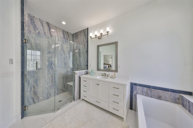 full bathroom with a textured ceiling, a garden tub, vanity, a marble finish shower, and tile patterned floors