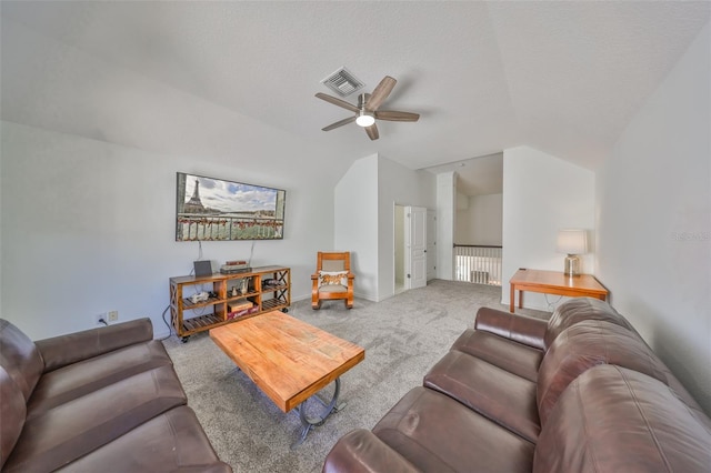 living area with visible vents, ceiling fan, vaulted ceiling, a textured ceiling, and carpet flooring