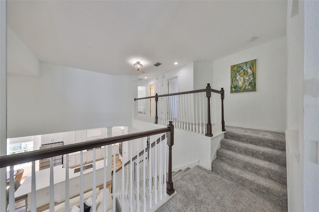 stairway with recessed lighting, carpet, visible vents, and baseboards