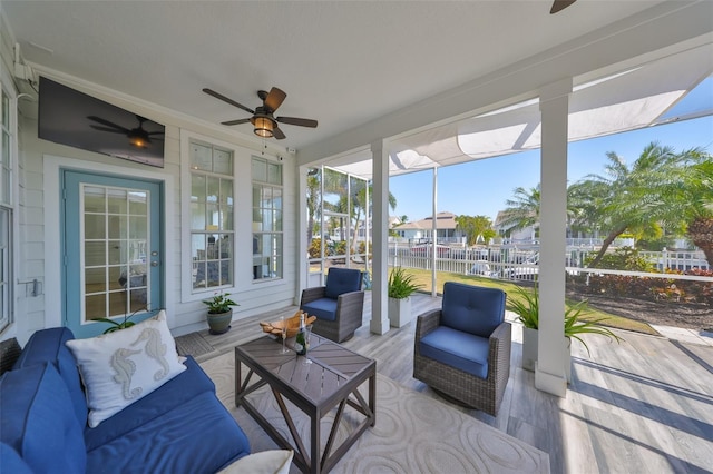 sunroom / solarium with a ceiling fan