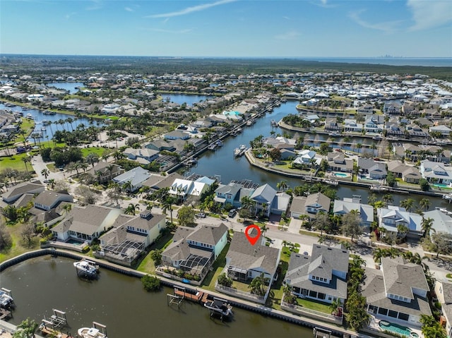 drone / aerial view featuring a residential view and a water view