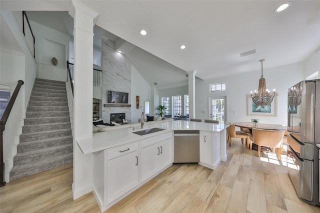 413 Islebay Dr, Apollo Beach, FL 33572 - kitchen featuring stainless steel appliances, a sink, light wood-type flooring, white cabinets, and recessed lighting