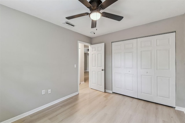 unfurnished bedroom with light wood-style flooring, a closet, visible vents, and baseboards