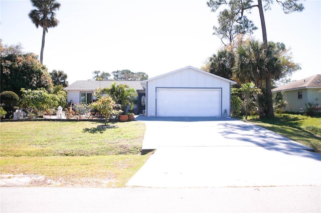 single story home featuring a garage, board and batten siding, concrete driveway, and a front yard