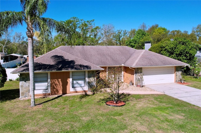 ranch-style home featuring a chimney, stone siding, a front yard, and a garage