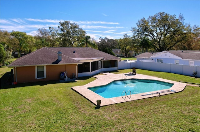 view of swimming pool featuring a yard, a patio, a fenced backyard, and a sunroom