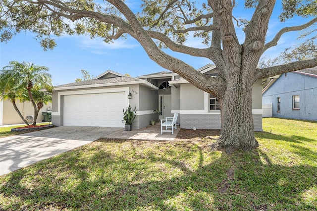 2519 Southern Oak Cir, Clearwater, FL 33764 - ranch-style home with brick siding, concrete driveway, an attached garage, a front yard, and stucco siding