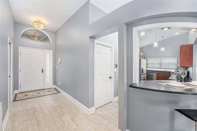 2519 Southern Oak Cir, Clearwater, FL 33764 - entrance foyer featuring lofted ceiling, baseboards, and light wood-style floors
