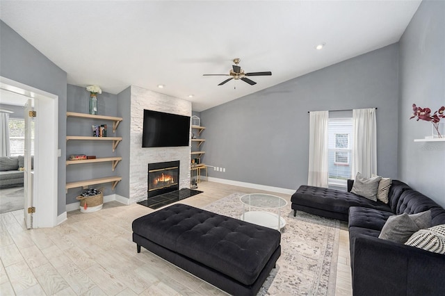 2519 Southern Oak Cir, Clearwater, FL 33764 - living room featuring a healthy amount of sunlight, vaulted ceiling, wood finished floors, and a stone fireplace