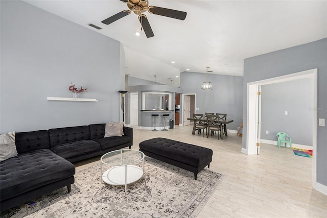 2519 Southern Oak Cir, Clearwater, FL 33764 - living area featuring wood finished floors, a ceiling fan, visible vents, vaulted ceiling, and baseboards