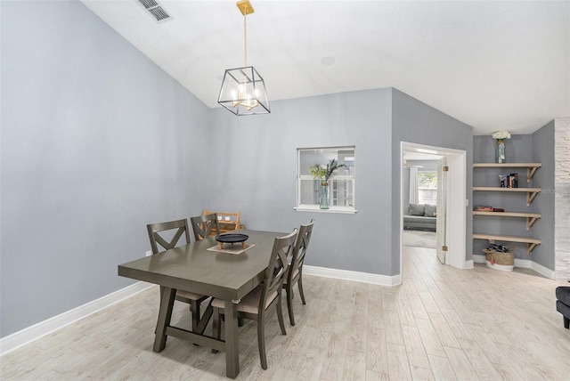 2519 Southern Oak Cir, Clearwater, FL 33764 - dining room featuring visible vents, vaulted ceiling, baseboards, and wood finished floors