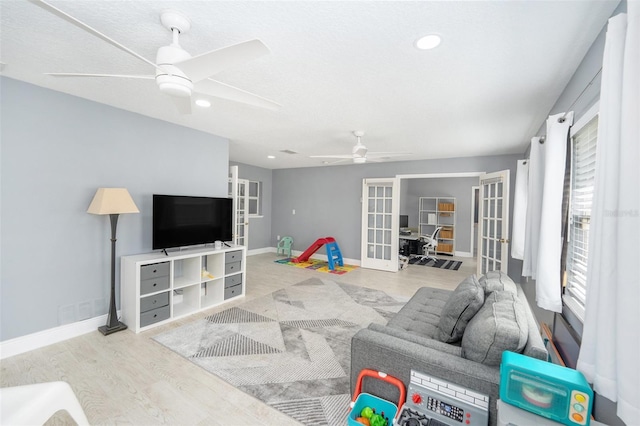 2519 Southern Oak Cir, Clearwater, FL 33764 - living area with a ceiling fan, french doors, baseboards, and wood finished floors