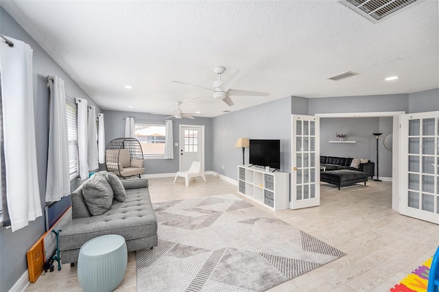 2519 Southern Oak Cir, Clearwater, FL 33764 - living room with light wood-type flooring, baseboards, visible vents, and french doors