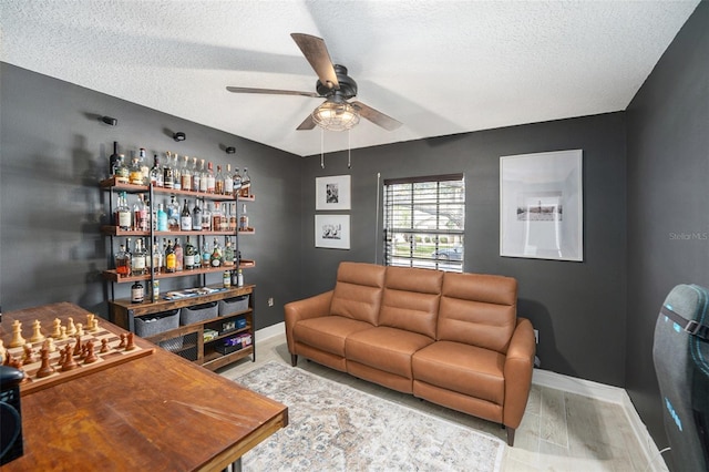 2519 Southern Oak Cir, Clearwater, FL 33764 - living room featuring a dry bar, ceiling fan, a textured ceiling, wood finished floors, and baseboards