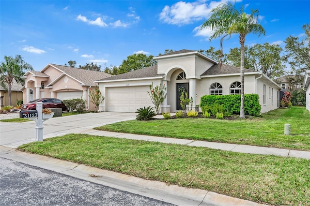 31123 Stone Arch Ave, Wesley Chapel, FL 33545 - view of front of home featuring driveway, a front yard, an attached garage, and stucco siding