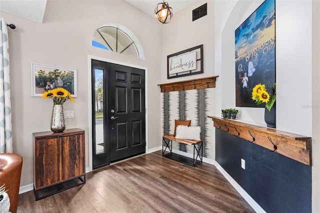 31123 Stone Arch Ave, Wesley Chapel, FL 33545 - foyer entrance with visible vents, a towering ceiling, baseboards, and wood finished floors
