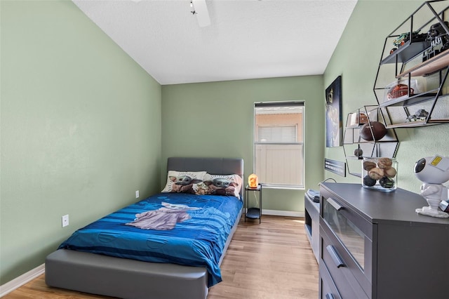31123 Stone Arch Ave, Wesley Chapel, FL 33545 - bedroom with a ceiling fan, a textured ceiling, baseboards, and wood finished floors