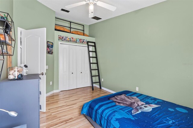 31123 Stone Arch Ave, Wesley Chapel, FL 33545 - bedroom featuring ceiling fan, wood finished floors, visible vents, baseboards, and a closet