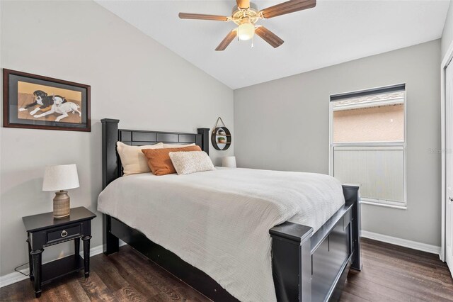31123 Stone Arch Ave, Wesley Chapel, FL 33545 - bedroom with dark wood-style floors, ceiling fan, baseboards, and vaulted ceiling