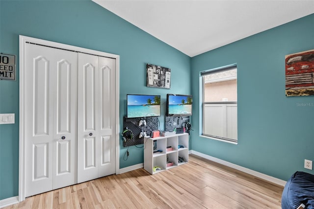 31123 Stone Arch Ave, Wesley Chapel, FL 33545 - rec room with lofted ceiling, baseboards, and wood finished floors