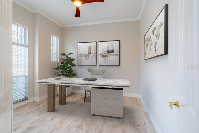 home office featuring crown molding, light wood-style flooring, and baseboards