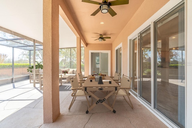 view of patio with a ceiling fan, outdoor dining area, and a lanai