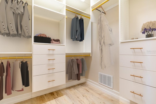 walk in closet featuring light wood-type flooring and visible vents