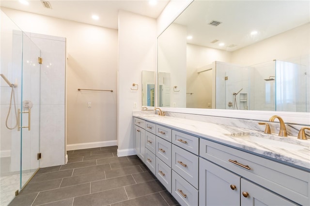 full bathroom featuring double vanity, a sink, visible vents, and a shower stall