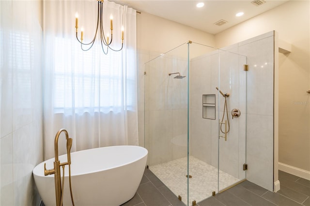 bathroom with a stall shower, tile patterned flooring, a freestanding bath, and recessed lighting