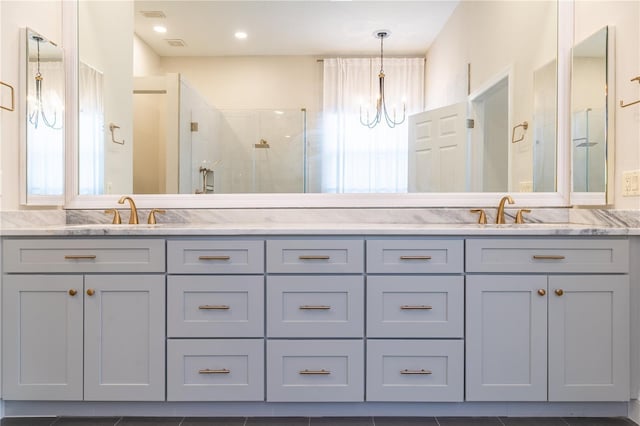 full bathroom with a stall shower, plenty of natural light, and a sink