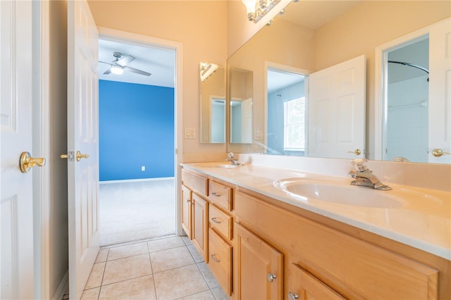 bathroom with double vanity, a sink, baseboards, and tile patterned floors