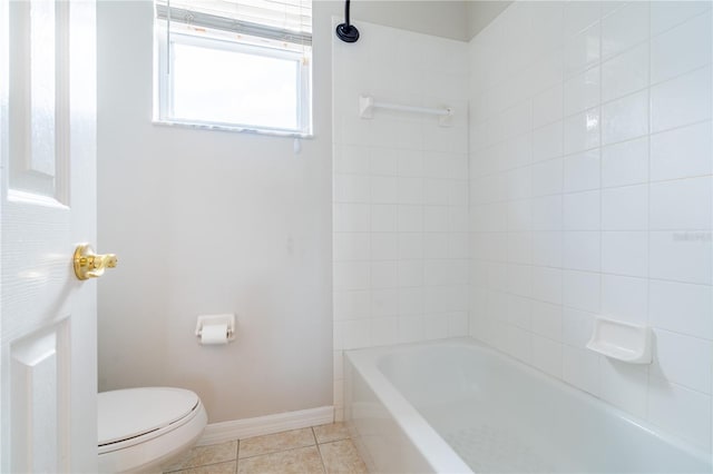 bathroom with baseboards, shower / washtub combination, toilet, and tile patterned floors