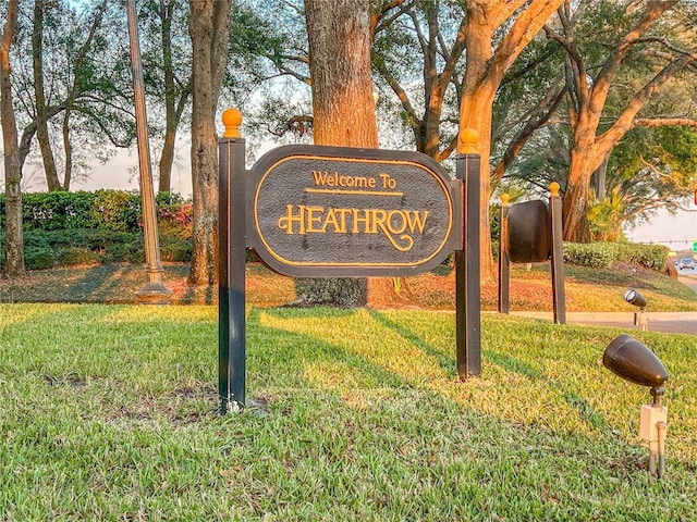 community / neighborhood sign with a lawn