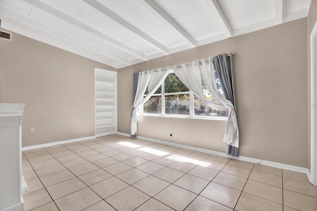 tiled spare room with lofted ceiling with beams, visible vents, and baseboards