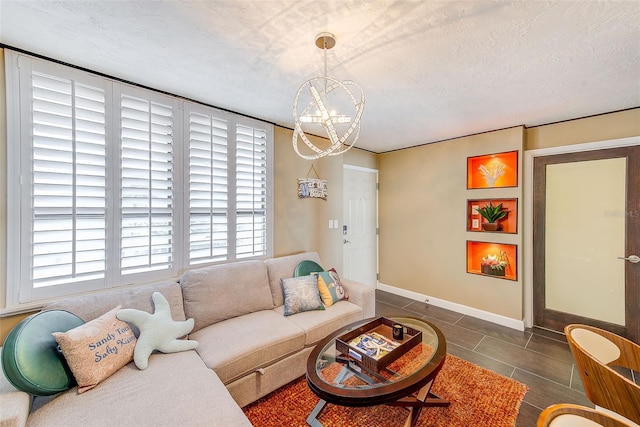 tiled living area featuring a notable chandelier, baseboards, and a textured ceiling