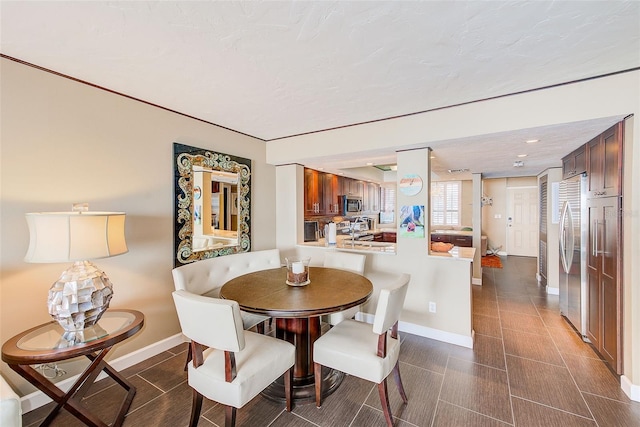 dining room with dark tile patterned floors, recessed lighting, and baseboards