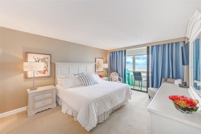 bedroom featuring access to outside, light colored carpet, a textured ceiling, and baseboards