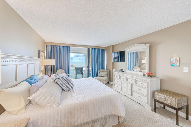 bedroom featuring a textured ceiling and light colored carpet