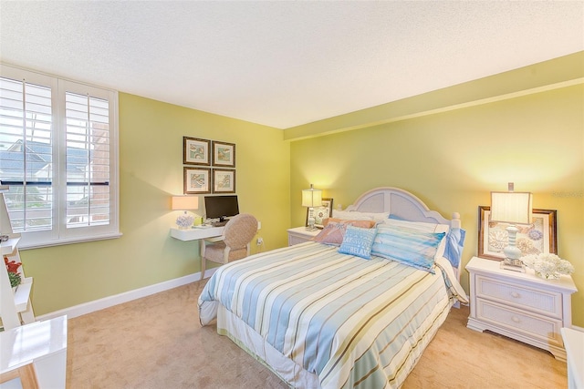 bedroom with light carpet, a textured ceiling, and baseboards