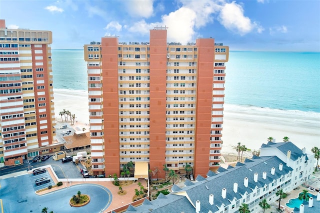 view of property with a water view and a view of the beach