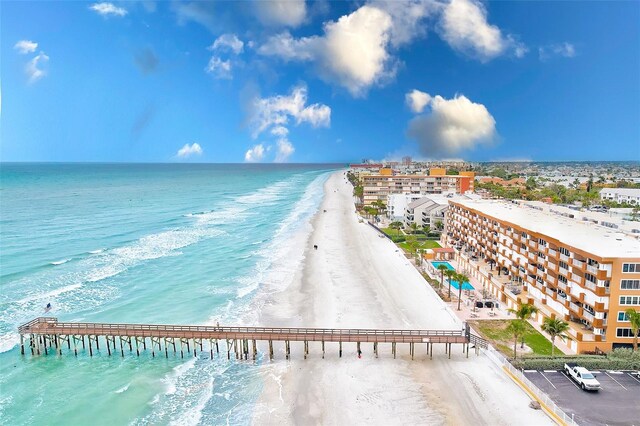 water view featuring a pier and a beach view