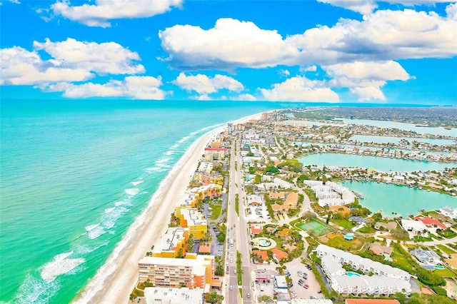 bird's eye view with a water view and a beach view