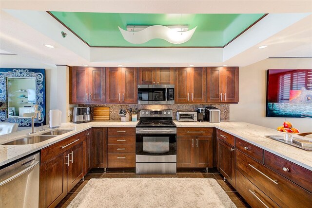 17940 Gulf Blvd Unit 2B, Redington Shores, FL 33708 - kitchen with stainless steel appliances, a peninsula, tasteful backsplash, a sink, and recessed lighting