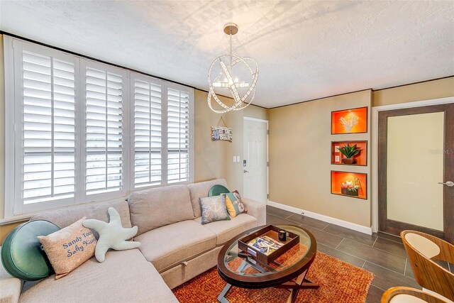 17940 Gulf Blvd Unit 2B, Redington Shores, FL 33708 - tiled living area featuring a chandelier, baseboards, and a textured ceiling