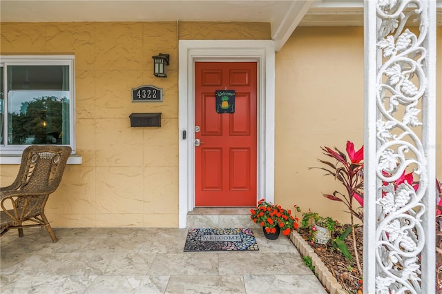 view of exterior entry with stucco siding